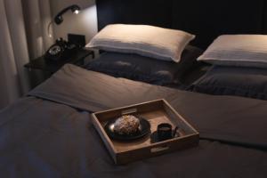 a tray with a donut in a bowl on a bed at Riverside City View & free parking in Rzeszów