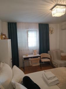 a room with a bed and a table and a couch at Zelena oaza in Baška Voda