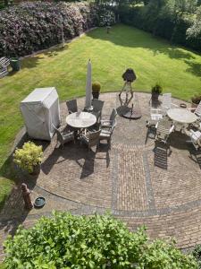 a patio with a table and chairs and a tv at FeWo Strandgut in Großefehn 