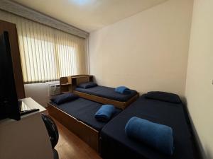 a small room with two beds and a window at Hospedagem Canal do Bora Viajar in Rio de Janeiro +48 photos