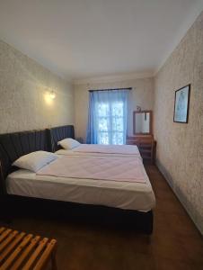 a bedroom with two beds and a window at HOTEL IREON beach in Samos