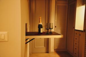 a bottle of wine on a table in a room at Le Cœur Urban Suite Parma in Parma +18 photos