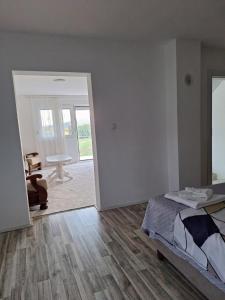 a bedroom with a bed and a door to a patio at Sunrise369 in Beoci