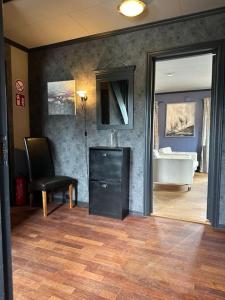 a living room with a tub and a room with a chair at Villa Hagevegen 3 A, Porsgrunn in Porsgrunn