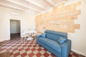 a living room with a blue couch and a table at Terrazza Nostromo Francesco in Trani