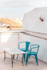 two chairs and a table and a bench on a balcony at Terrazza Nostromo Francesco in Trani