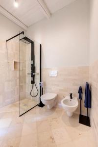 a bathroom with a shower and a toilet and a sink at Terrazza Nostromo Francesco in Trani