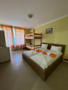 a bedroom with a large bed in a room at Hotel Laguna - Guest House in Primorsko