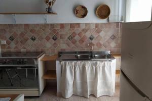 Kuchyň nebo kuchyňský kout v ubytování Casa Indipendente nel Cuore della Costa Smeralda Comfort per Famiglie e Gruppi + 10 fotografií