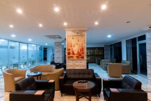 a lobby with couches and chairs and a fireplace at Grand Hotel Derin-All Inclusive in Beldibi