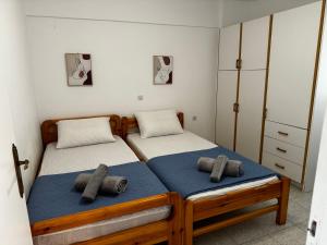 a bedroom with two twin beds with towels on them at Raches Prime Apartments in Paralia Rachon +24 photos