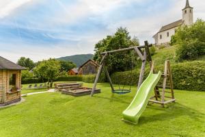 a playground with a slide in the grass at Haus König in Mauterndorf
