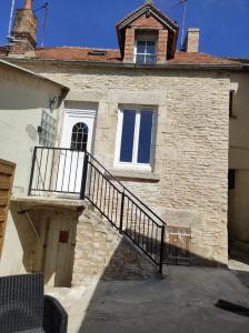アランソンにあるla maison du bonheurの階段と窓のある石造りの建物