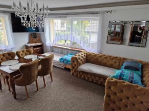 a living room with a couch and a table at AGNES in Grzybowo