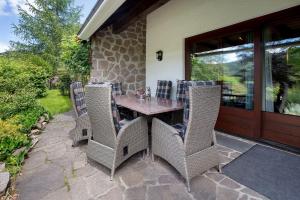 a table and chairs sitting on a patio at Amadeus Black Forest Mountain in Todtmoos