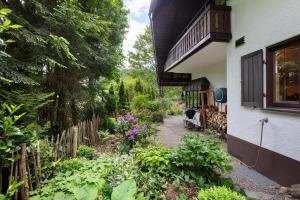 a garden outside a house with a fence and flowers at Amadeus Black Forest Mountain in Todtmoos