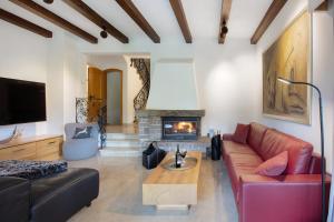a living room with a couch and a fireplace at Amadeus Black Forest Mountain in Todtmoos