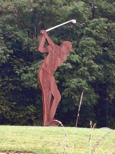 a statue of a person swinging a golf club at Gite la petite pataudiere in Le Guédéniau