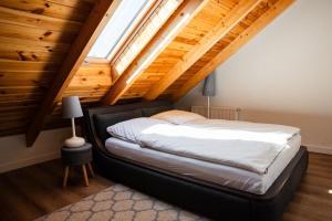 a bedroom with a bed in the attic at Apartamenty Ogródkowa 5 in Wisła +25 photos