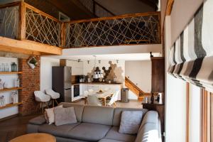 a living room with a couch and a kitchen at Apartamenty Ogródkowa 5 in Wisła