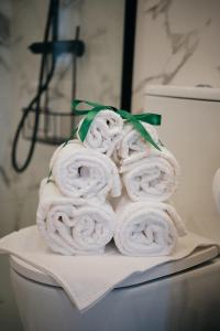 a pile of towels sitting on top of a toilet at Mponto in Ponte da Barca