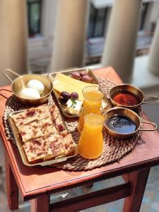 a tray of food on a wooden table with drinks at Champollion Palace in Cairo +46 photos