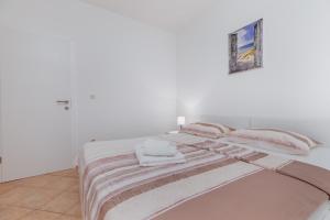 Postel nebo postele na pokoji v ubytování Sita Apartmani