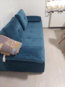 a blue couch sitting on top of a floor at Apartman Mila in Županja +9 photos