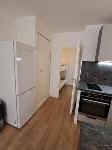 an empty kitchen with a stove and a refrigerator at Studio BERNARD in Saint-Cyr-sur-Mer +11 photos