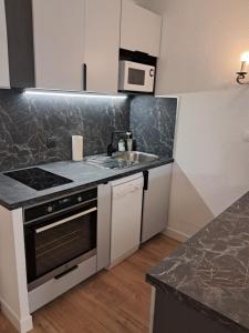a kitchen with a sink and a stove at Studio BERNARD in Saint-Cyr-sur-Mer