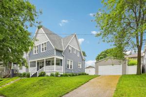 a gray house with a gambrel roof at Historic Home in Brewers Hill with hot tub! in Milwaukee