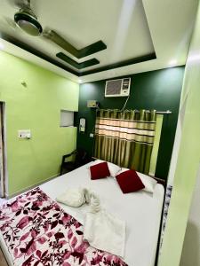 a bedroom with a bed with red and green walls at Maa Durga Inn in Varanasi