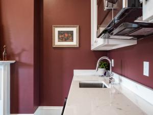 a kitchen with red walls and a sink at The Chester Hotel in Boston +98 photos
