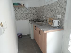a small kitchen with a sink and a counter at Levantes Hotel in Patitiri +42 photos