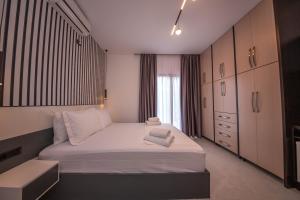 a bedroom with a large bed with white sheets at Vila Olserd Shehu in Ksamil