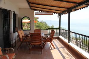a balcony with a table and chairs on it at Villa Panorama Struga, Elen Kamen in Struga