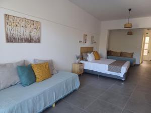 a living room with two beds and a couch at Levantes Hotel in Patitiri