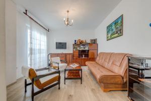 a living room with a couch and a table at Seafront apartments Marija in Rogoznica