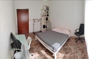 a bedroom with a bed and a desk and a computer at White house in Bari