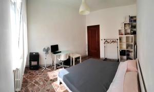 a bedroom with a bed and a desk in it at White house in Bari
