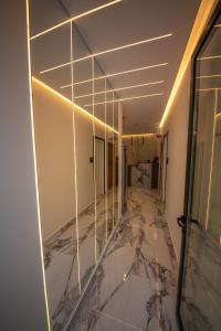 an empty room with a marble floor and glass walls at Vila Olserd Shehu in Ksamil