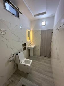 a bathroom with a toilet and a sink at Resid'homes Appart'hotel SaintLouis in Saint-Louis +35 photos