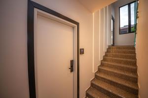 a hallway with a door leading up to a staircase at Vila Olserd Shehu in Ksamil