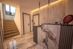 a lobby with a marble counter and stairs at Vila Olserd Shehu in Ksamil