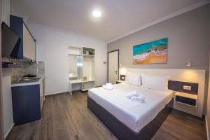a hotel room with a bed and a sink at Vila Olserd Shehu in Ksamil