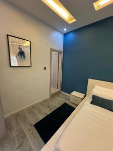 a bedroom with a bed and a blue wall at Welcome Home 102 SaintLouis in Saint-Louis +13 photos