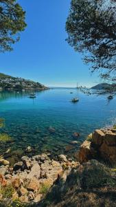 a large body of water with a boat in it at CAN ROMY APPARTEMENT T1 C - à 80m de la plage de Cala Montgo in L'Escala