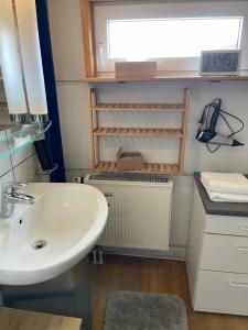 a bathroom with a sink and a window at Haus mit Aussicht S3-Bahn, B14-Straße, WLAN in Schwaikheim +10 photos