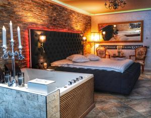 锡纳亚Wenge Studio & Spa的一间带大床和浴缸的卧室