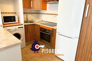 a kitchen with a chicken in the middle of a kitchen at Sol y Mar in Almería